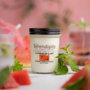 Serendipity candle with watermelon and mint theme on a blurred background